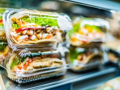 Chilli chicken with pita, pre-packaged sandwiches displayed in a commercial refrigerator